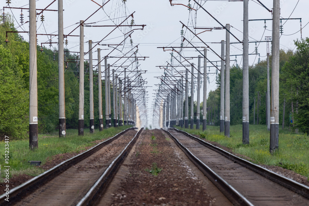 Summer heat washes out the railroad train electric way forming a natural tunnel.