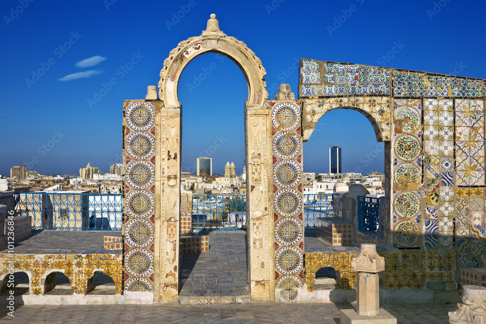 Naklejka premium Tunisia. Tunis - old town (medina) seen from roof top. Ornamental arches and wall covered tiles with geometric shape motifs