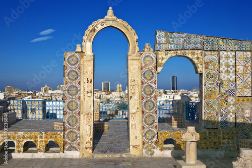 Tunisia. Tunis - old town (medina) seen from roof top. Ornamental arches and wall covered tiles with geometric shape motifs