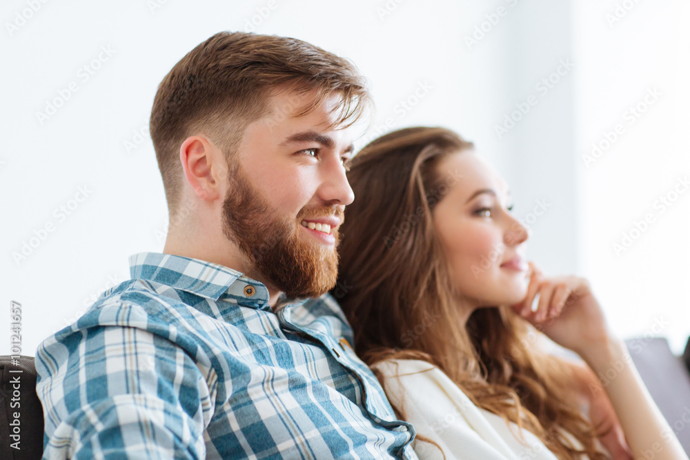 Couple watching TV on the sofa at home Couple watching TV on the sofa at home