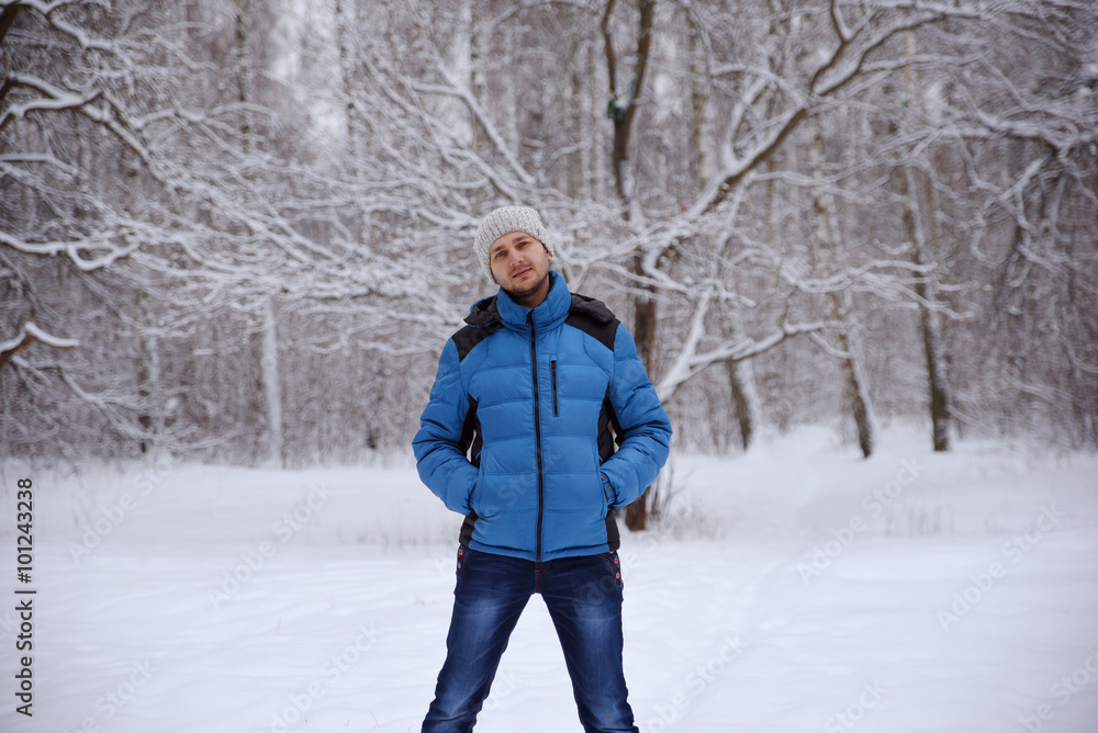 man in turn blue to the winter sport jacket stands in the snow f man in turn blue to the winter sport jacket stands in the snow f