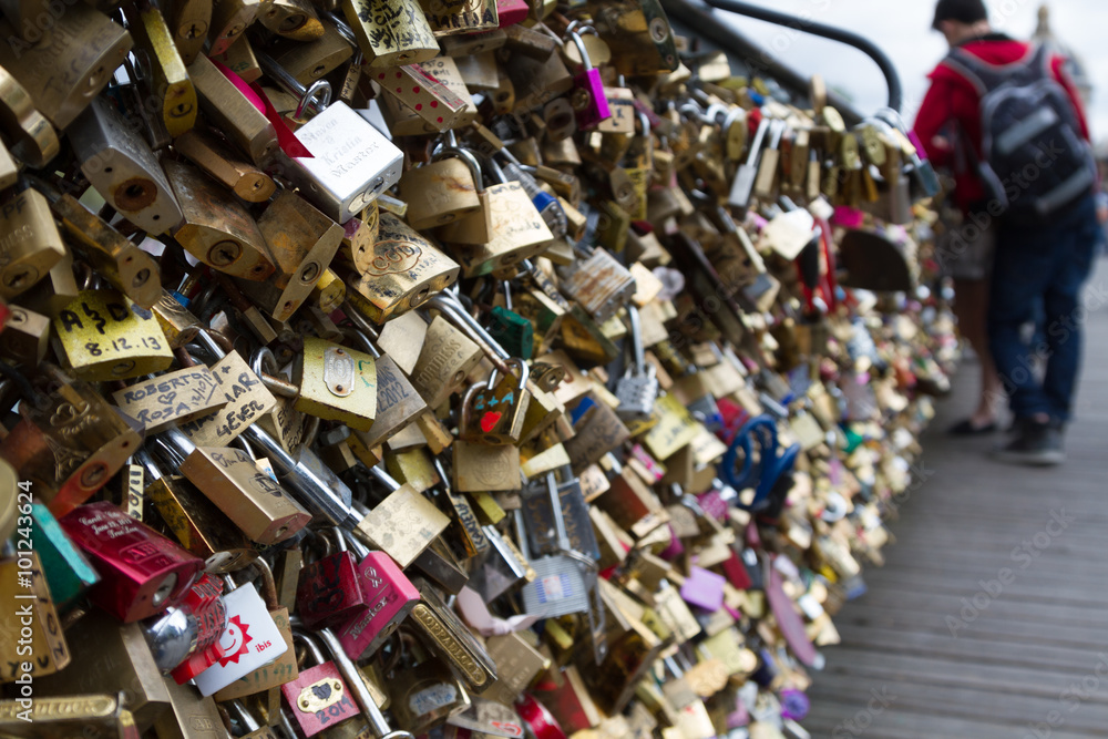 Padlocks known as love locks adorn the Pont des Arts bridge that spans the Seine River in Paris, France Padlocks known as love locks adorn the Pont des Arts bridge that spans the Seine River in Paris, France