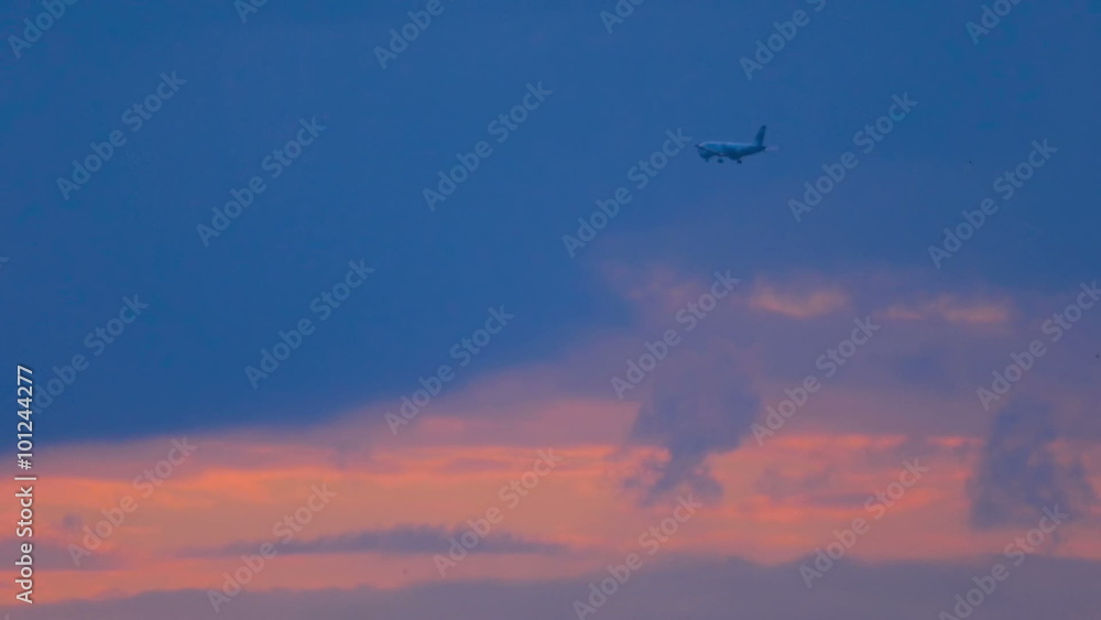 Plane is flying at sunset over the city Plane is flying at sunset over the city