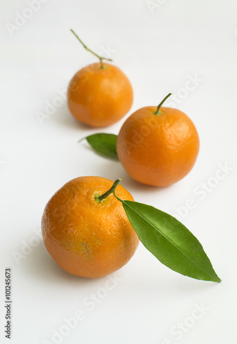 Mandarin fruits with green leaf on a white background