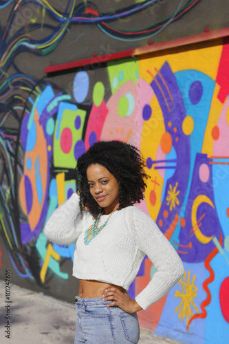 Woman posing by urban graffiti