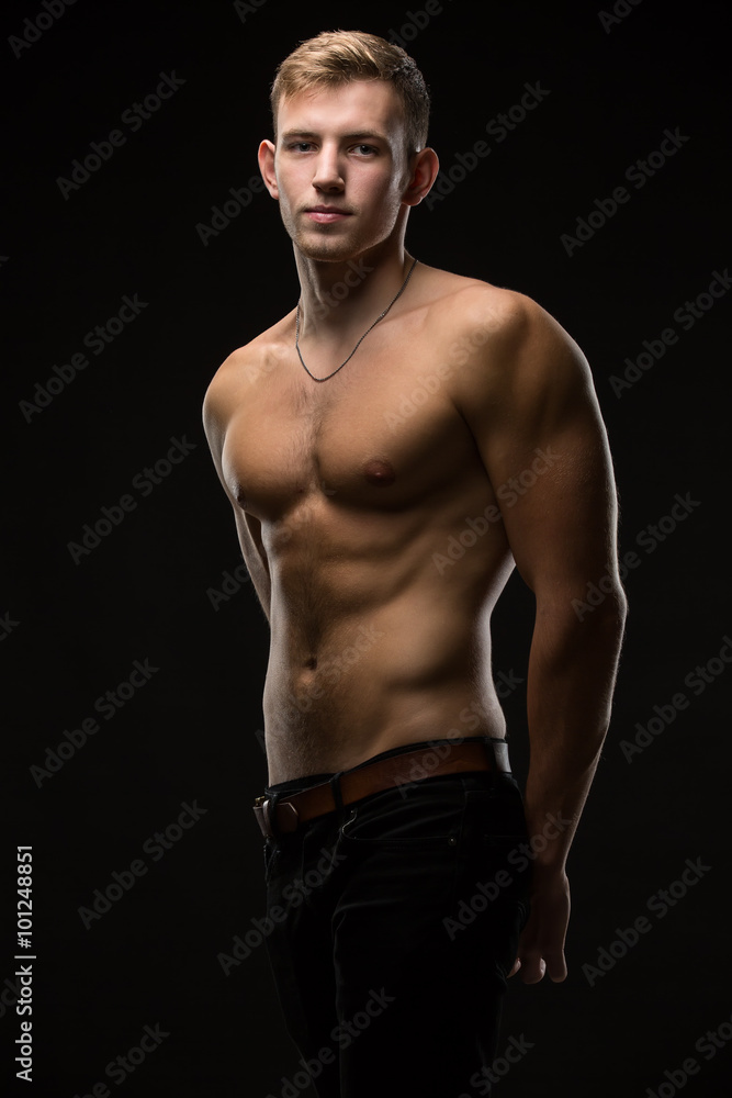 Fototapeta premium Guy in a black studio
