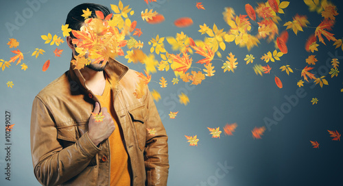Young man and falling autum...