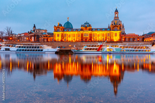 Academy of Fine Arts, tourist ships and Bruehl's Terrace aka The Balcony of Europe with reflections in the river Elbe at night in Dresden, Saxony, Germany