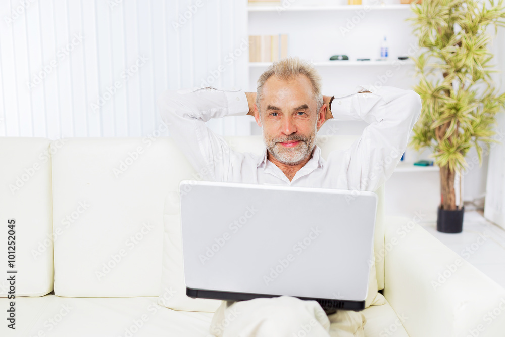 A successful businessman at the age of. Working at home A successful businessman at the age of. Working at home