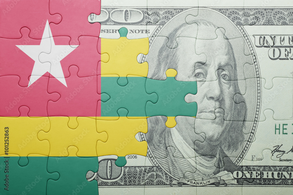 puzzle with the national flag of togo and dollar banknote puzzle with the national flag of togo and dollar banknote