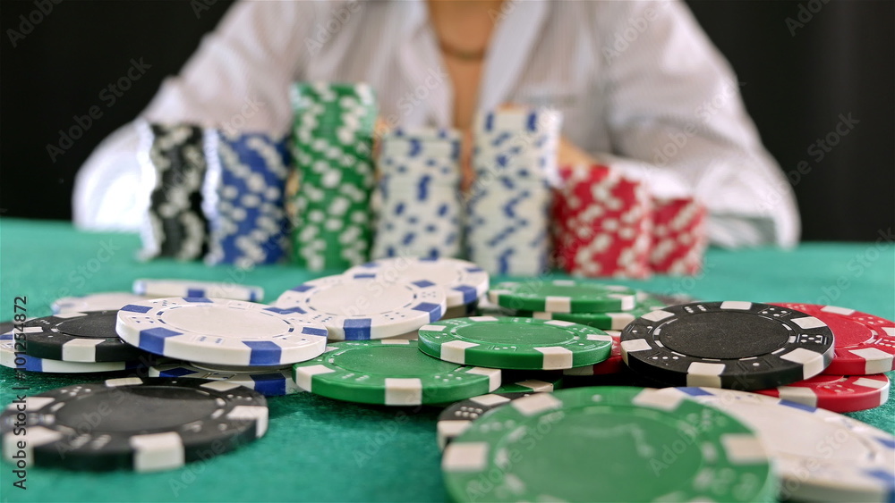 A gambler at a poker table doing fold A gambler at a poker table doing fold