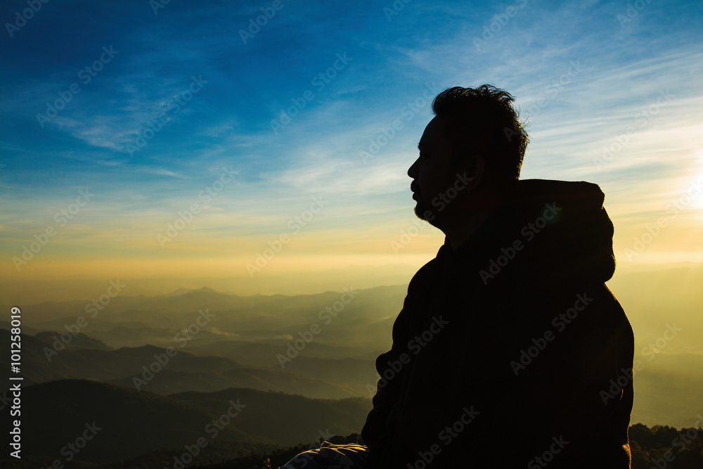 Silhouette of a man in the sunset on Mountain Landscape