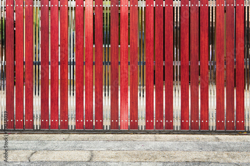 red painted wooden fence panels.