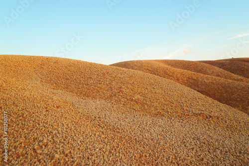 Tropical laterite soil or red earth background. Red mars seamless sand background.with blue sky.