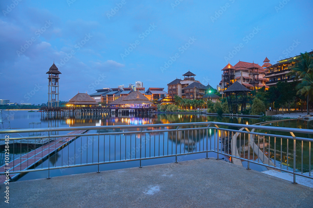Fototapeta premium Landscape of modern buildings by the lakeside with jetty in Putrajaya, Malaysia during twilight