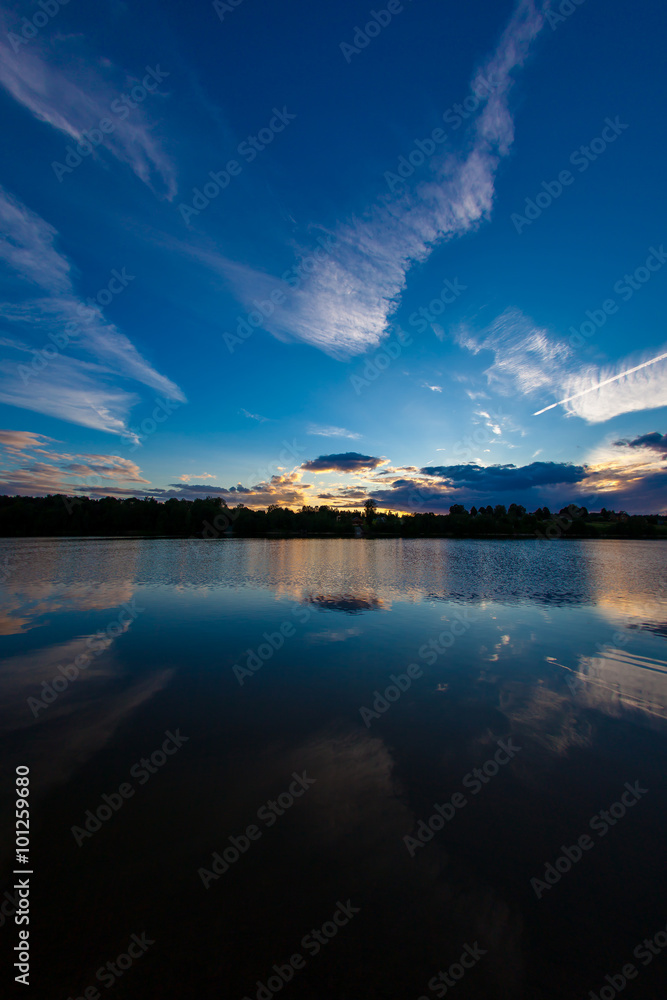 blue evening sky and smooth water surface