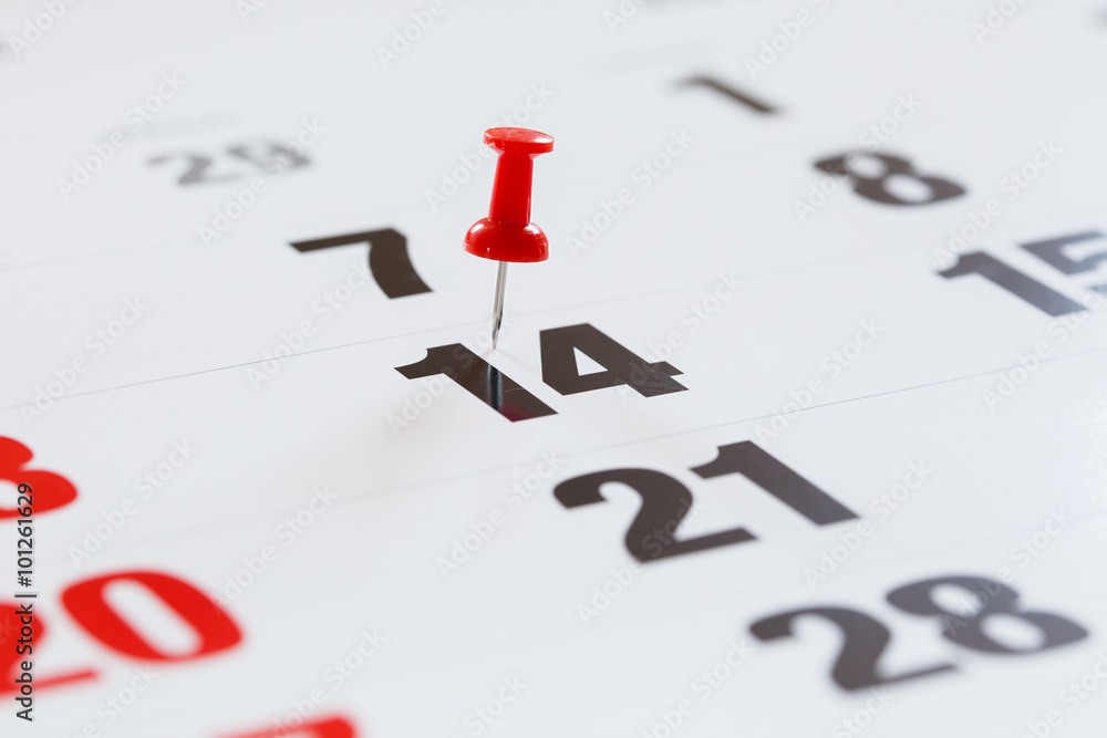 Pin pushed on a calendar concept for an important day. Pin pushed on a calendar concept for an important day.