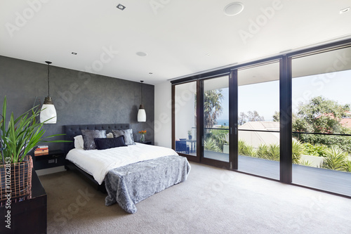 Fotografie Spacious interior of designer master bedroom in luxury Australia
