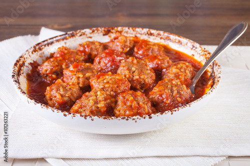 meatballs in tomato sauce in a bowl on a table, selective focus