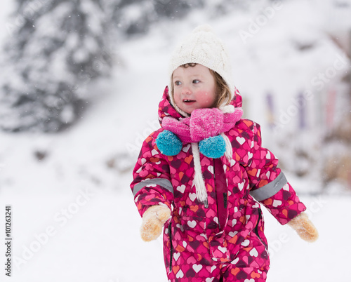 little girl at snowy winter day