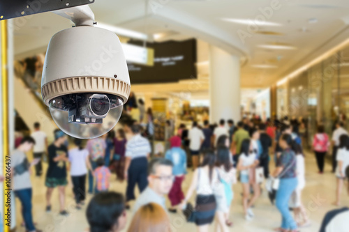 CCTV camera or surveillance operating with crowded people in bac