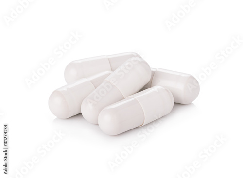 white pill capsules on white background