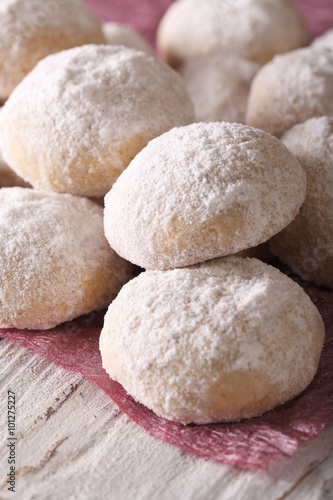 polvorón cookies with powdered sugar macro on a table. Vertical 