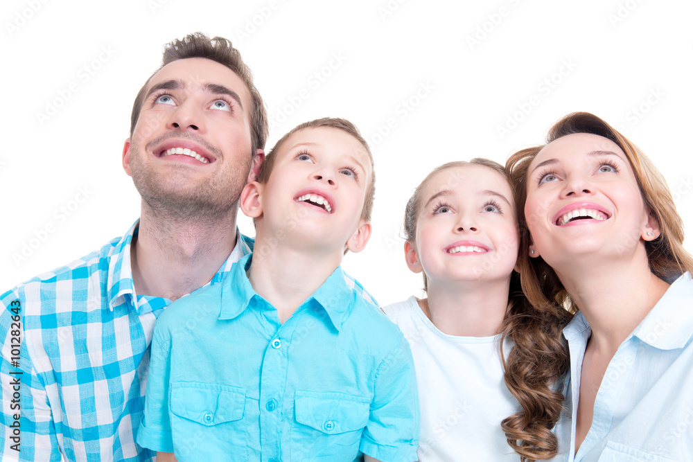 Happy family with two children looking up Happy family with two children looking up