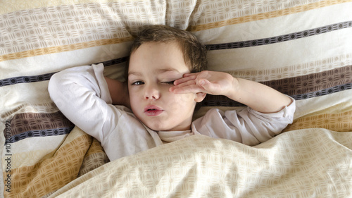 Sick or ill child in bed