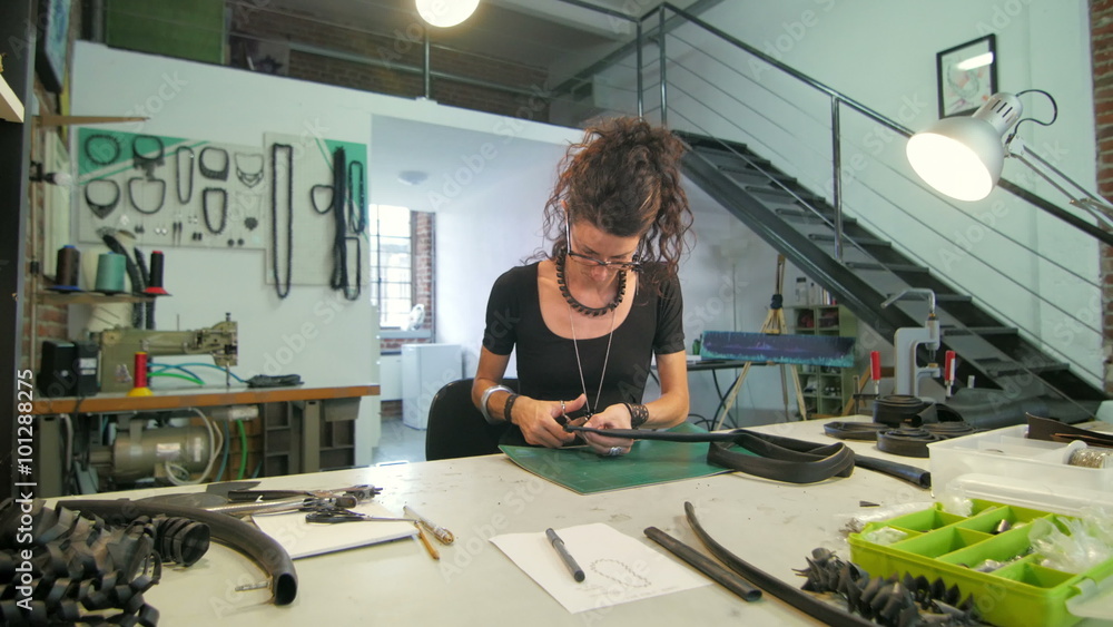 Young eco jewelry maker creating artwork in her atelier Young eco jewelry maker creating artwork in her atelier