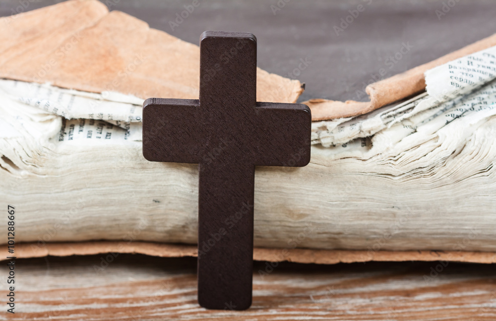Wooden Christian cross on bible.