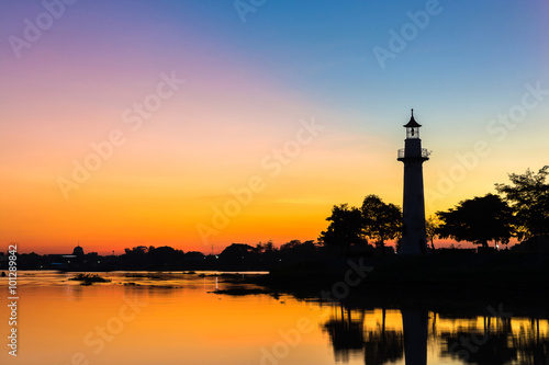Colorful beautiful sunset with The Silhouette of the lighthouse