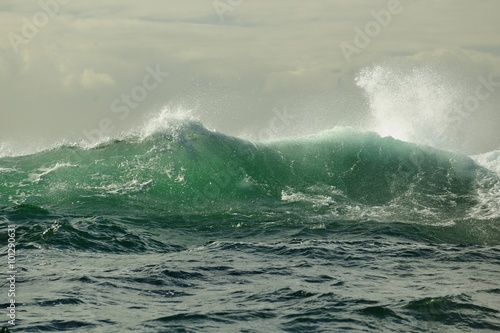 Powerful ocean wave breaking. Wave on the surface of the ocean. Wave breaks on a shallow bank. Natural background