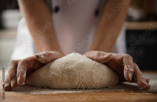 Canvas Print Close-up of female cook hands kneading dough for pizza or pasta in the kitchen