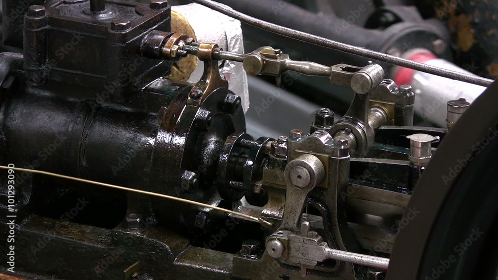 Stationary horizontal steam engine in operation with emphasis on the valve gear mechanism. Stationary horizontal steam engine in operation with emphasis on the valve gear mechanism.