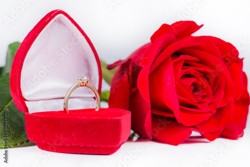 Golden engagement ring in a heart shaped box and roses (shallow © smspsy