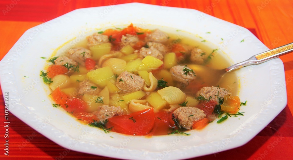 soup with meatballs and pasta in a white plate soup with meatballs and pasta in a white plate