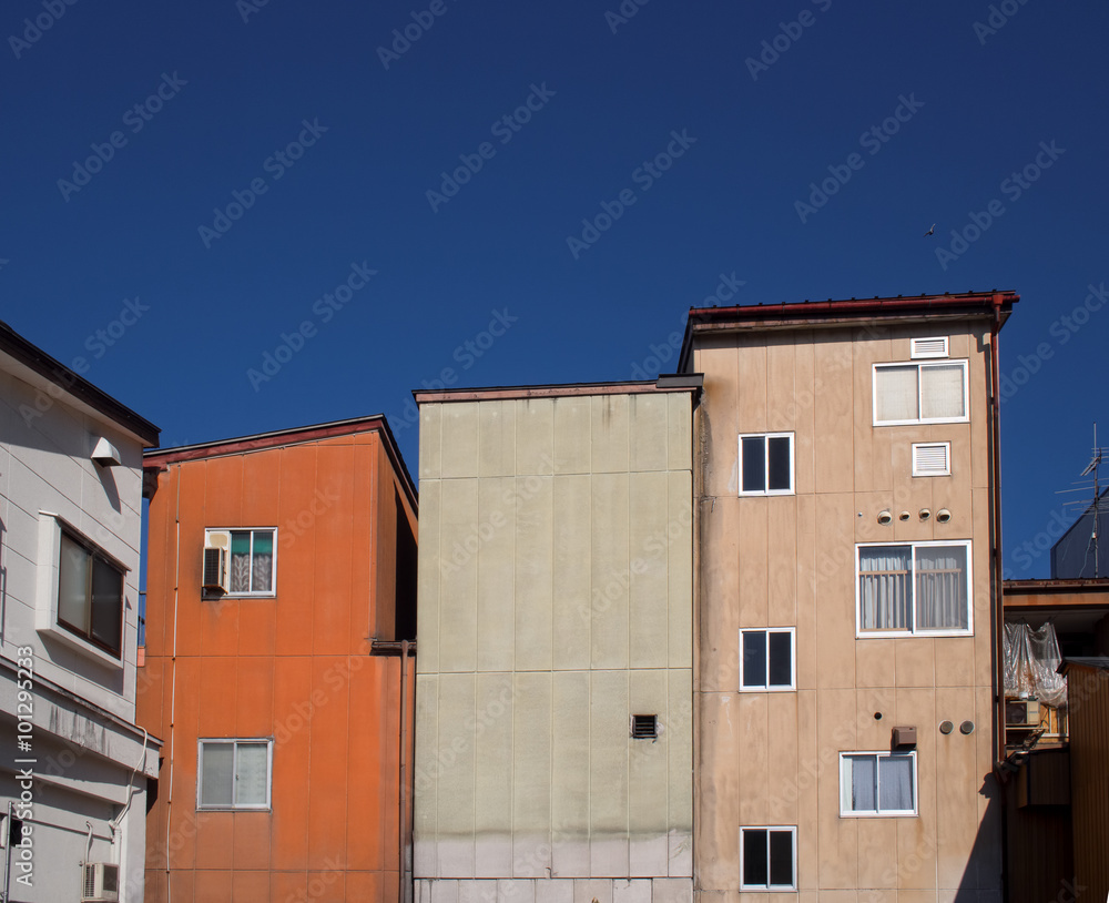 urban buildings against deep blue sky