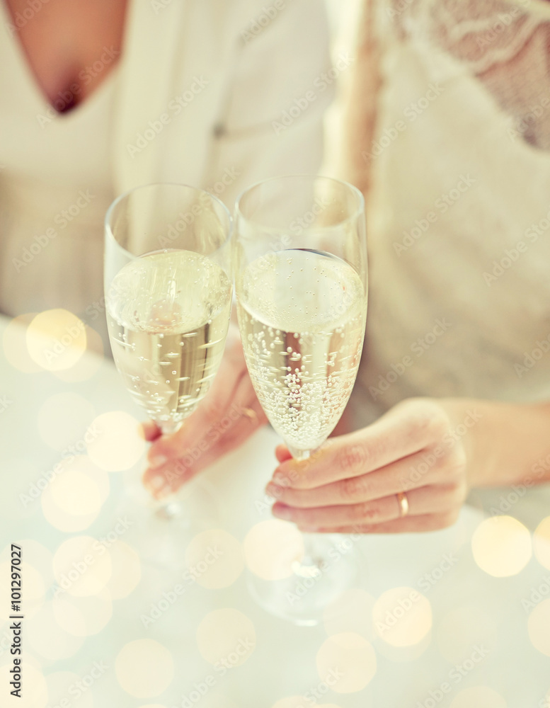 close up of lesbian couple with champagne glasses