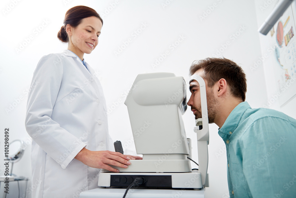 optician with tonometer and patient at eye clinic optician with tonometer and patient at eye clinic
