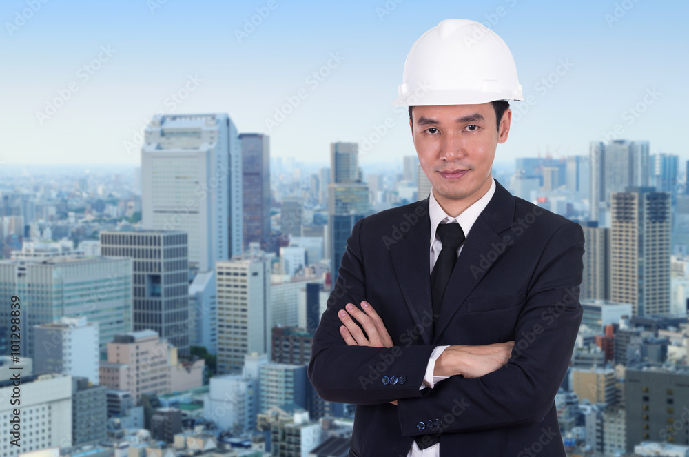 engineer in helmet with arms crossed, city background engineer in helmet with arms crossed, city background