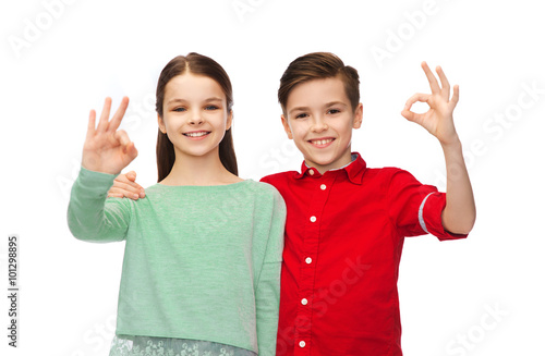happy boy and girl showing ok hand sign
