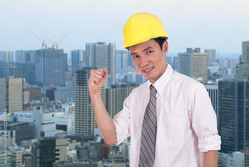 Happy engineer with arm raised, concept of successful, city back Happy engineer with arm raised, concept of successful, city back