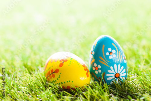 Colorful hand painted Easter eggs in grass. Spring theme