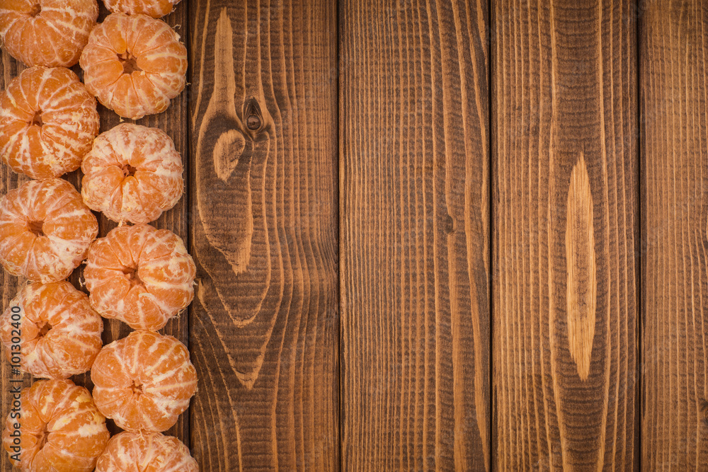 Peeled tangerine on a wooden table. Copy space. Peeled tangerine on a wooden table. Copy space.