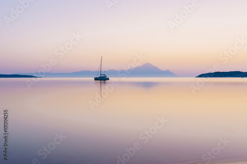 Yacht and blue water ocean with Athos mountain in the background - Greece, Europe photo