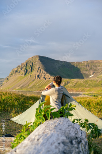 Photo of girl camping in Hornstrandir National Park, Iceland.