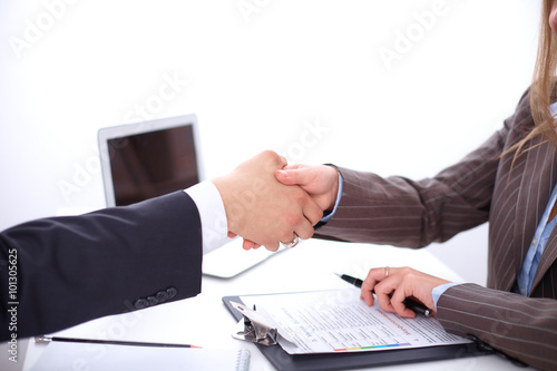 business handshak  sitting at the desk on office background, copy space area at the left upper corner