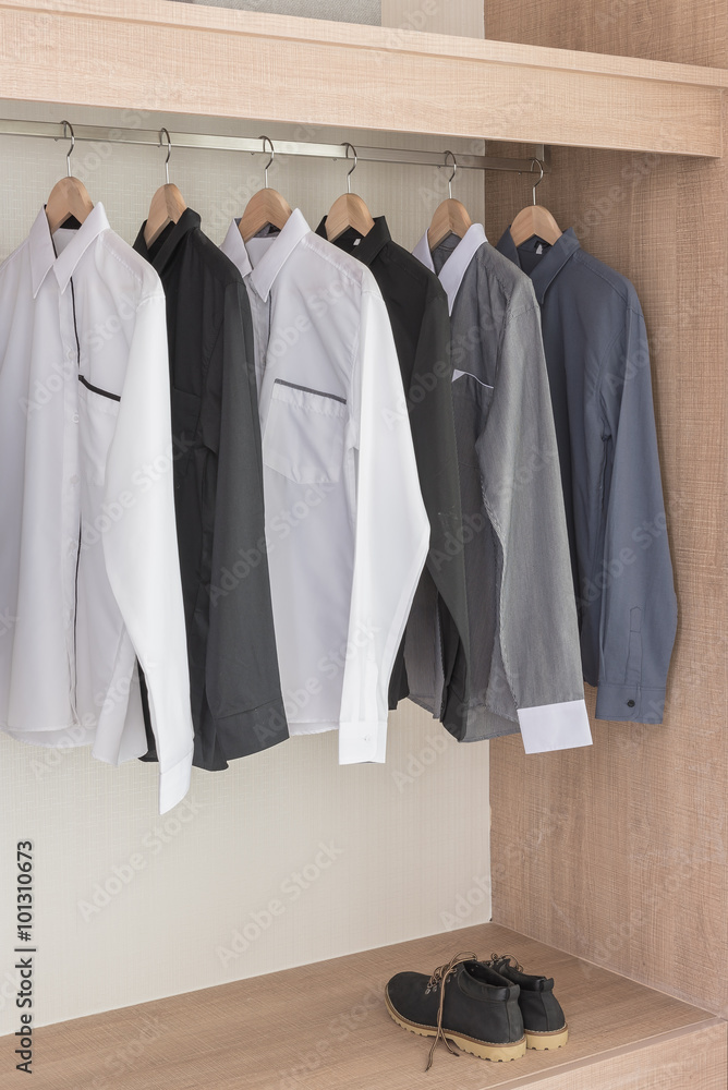 shirts hanging on rail in modern wooden wardrobe shirts hanging on rail in modern wooden wardrobe