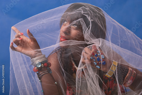 Woman with bracelets and tulie at studio portait with blue background photo